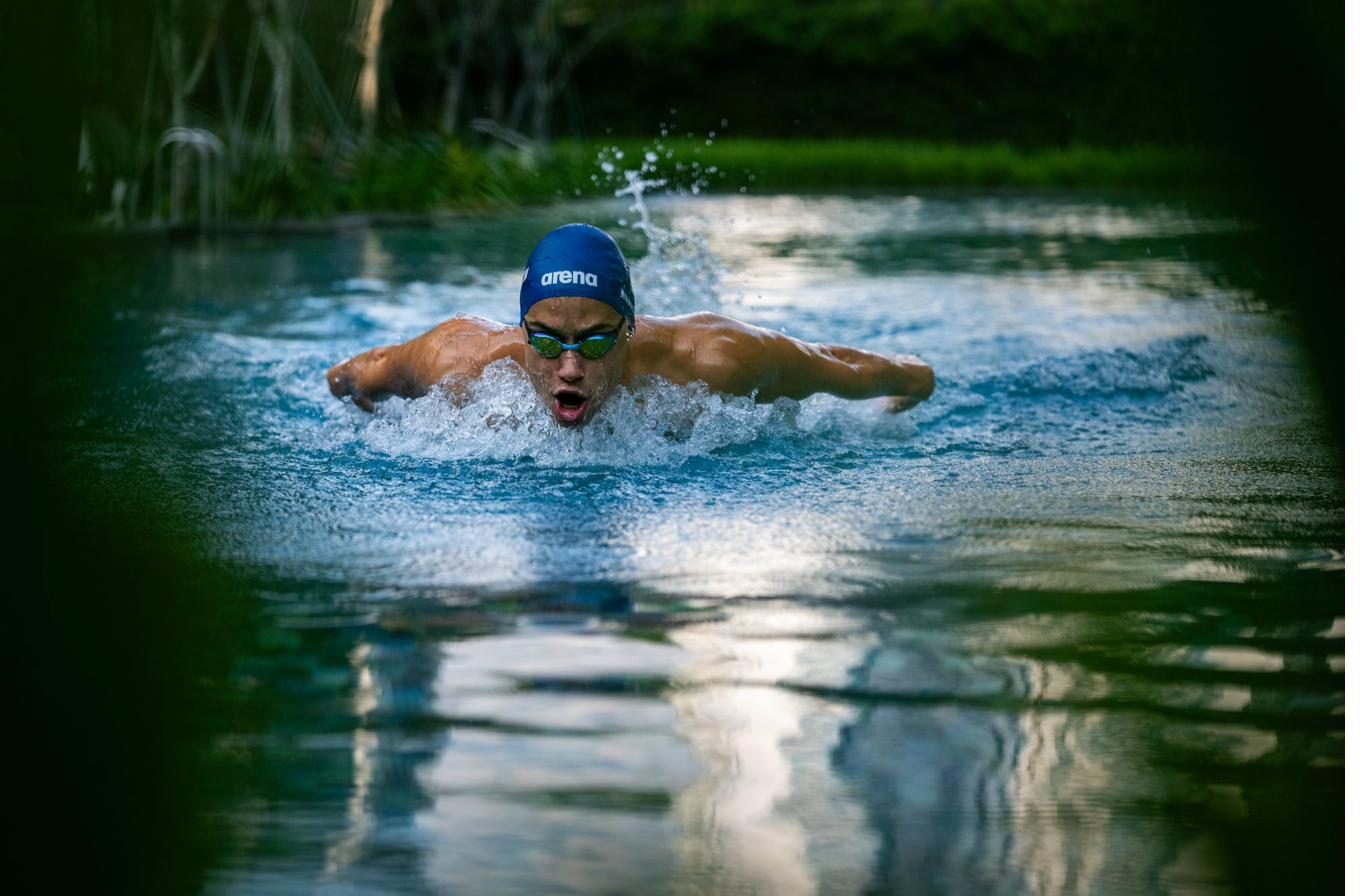 Butterfly swimmer breaking through the surface